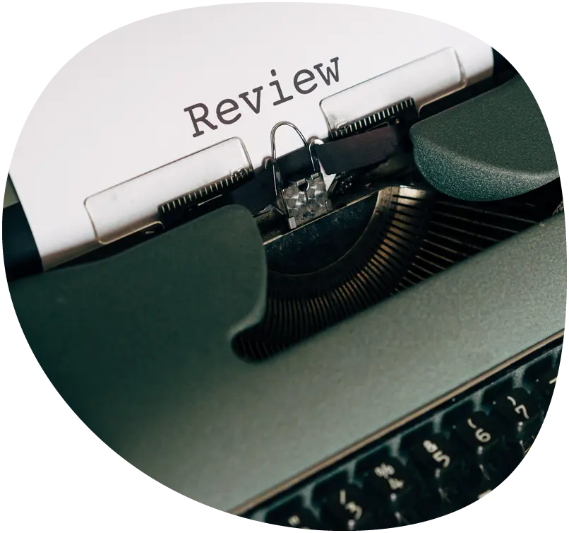 Typewriter typing reviews on a piece of paper