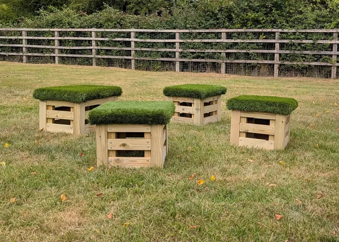 Set of 4 small artificial Grass Top Square Play Seats on grass field